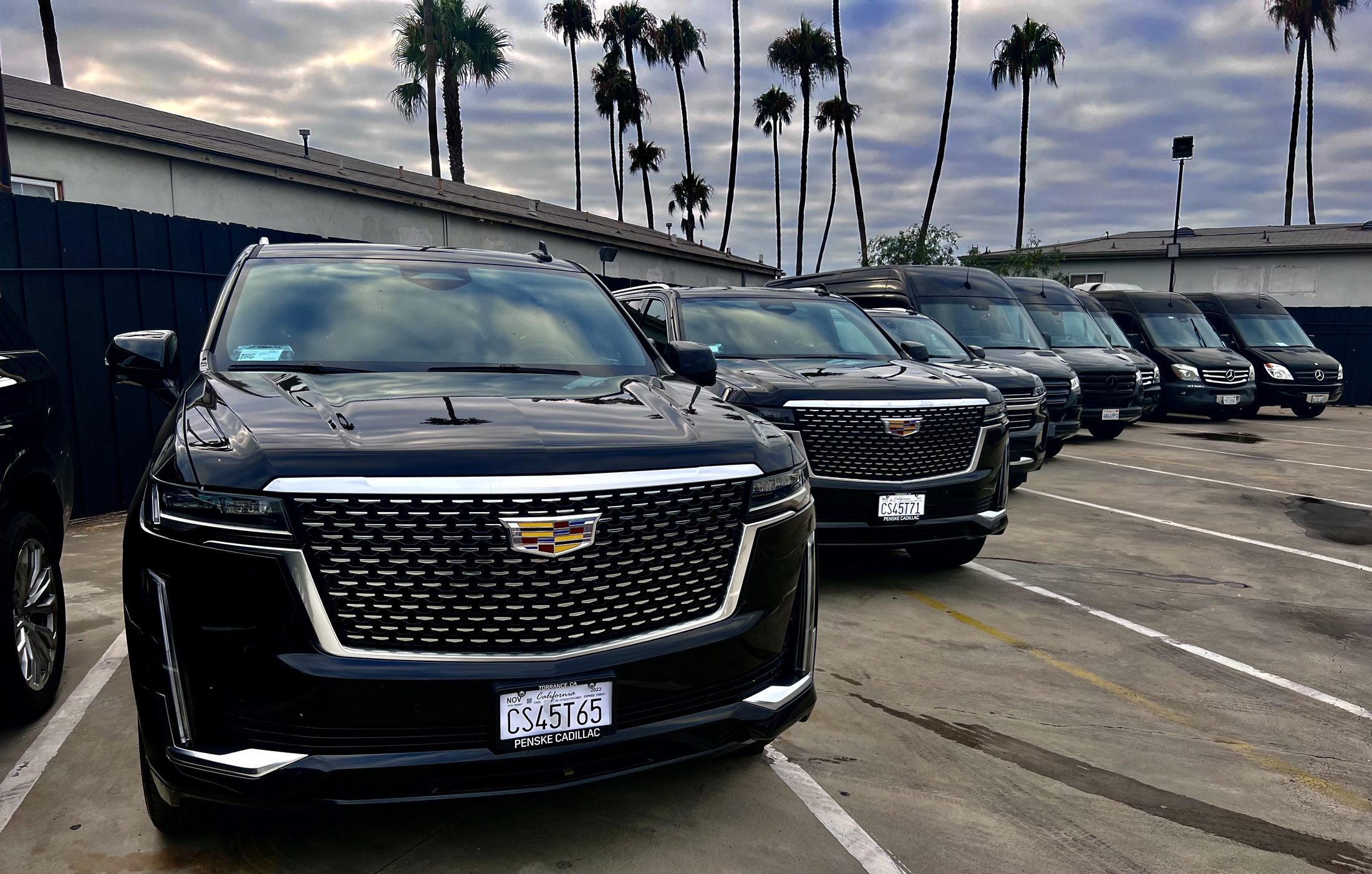 Luxier's owned fleet of black Cadillac Escalades and Mercedes Sprinters